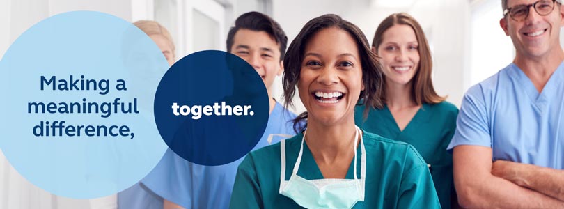 Hospital staff standing side by side smiling at camera, with the text &#39;Making a meaningful difference, together&#39; overlaying transparent circles