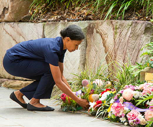 A St Andrew’s War Memorial Hospital employee lays a wreath at the hospital’s monument. 