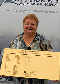 St Andrew's Hospital volunteer Carole Lyall with the plaque acknowledging long-term hospital volunteers