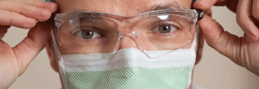 Surgeon putting glasses on